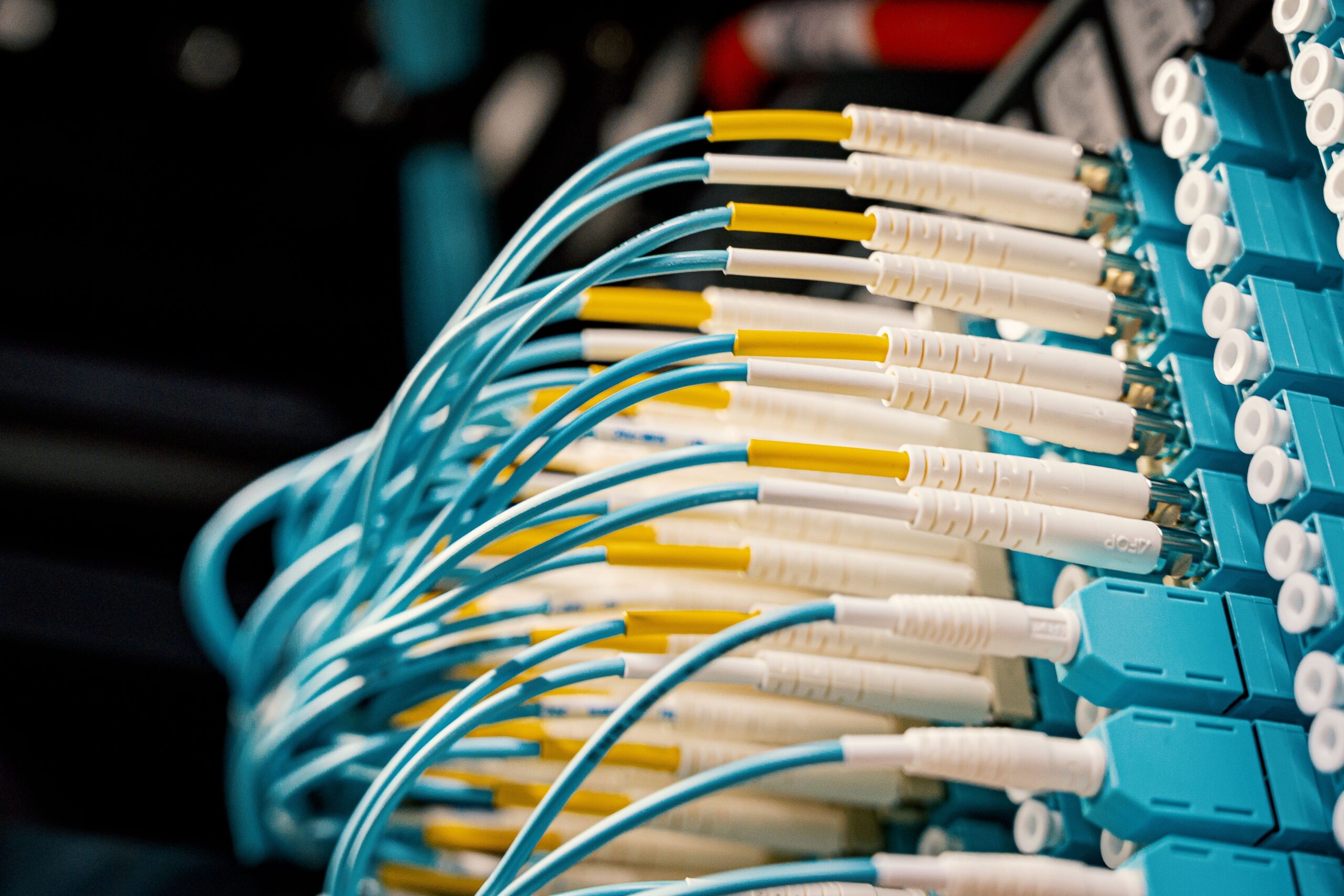 Fiber optic cables connected to a patch panel, serving as a metaphor for the high-speed gRPC and Apache Arrow communication in Spark Connect.