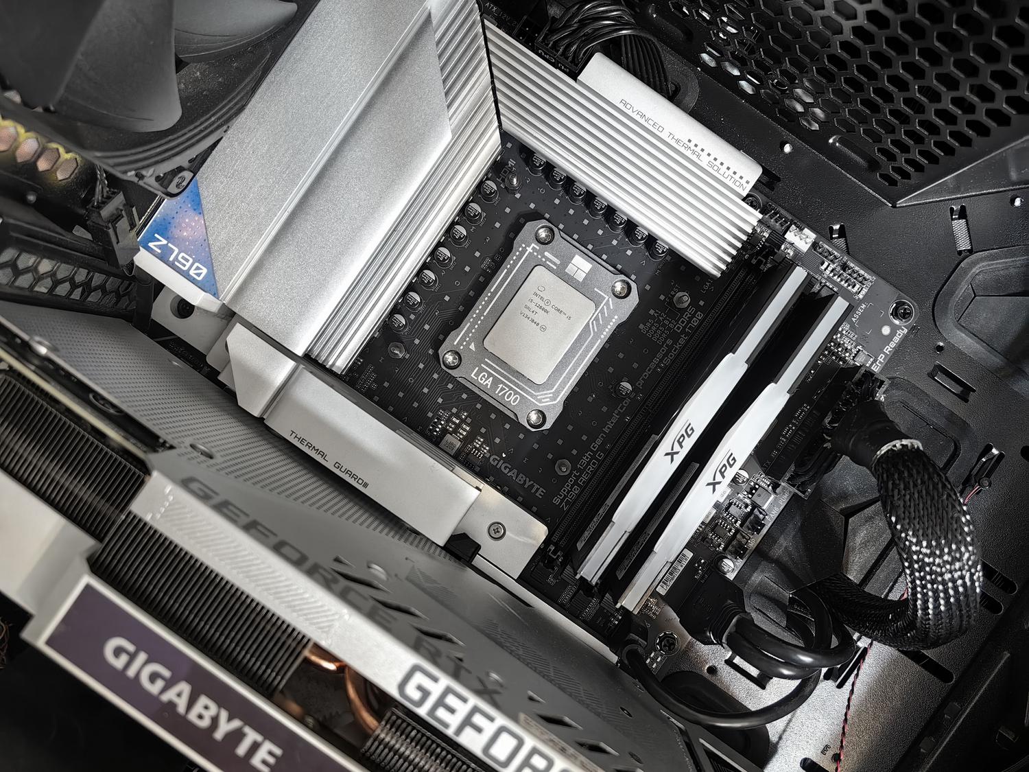 Vista detallada de una placa base Gigabyte Z790 con procesador Intel y memoria RAM DDR5 instalados. Vista detallada de una placa base Gigabyte Z790 con procesador Intel y memoria RAM DDR5 instalados.