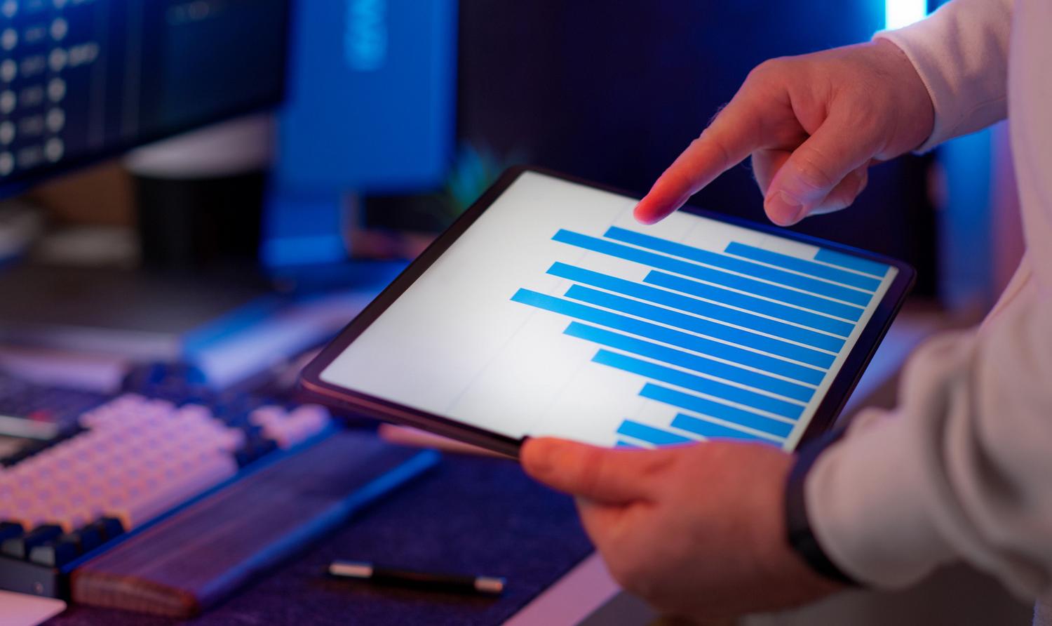 Profesional analizando métricas de telemetría en tiempo real en una tablet para detectar anomalías en el sistema.