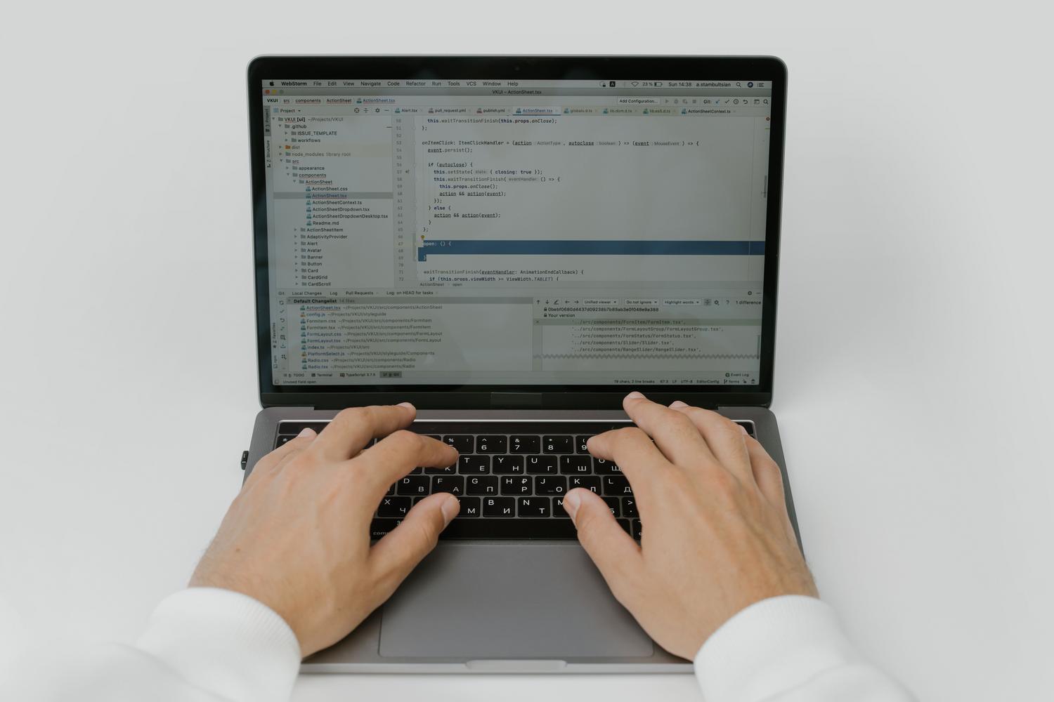 Close-up of hands typing on a laptop keyboard, illustrating the process of editing Markdown files.