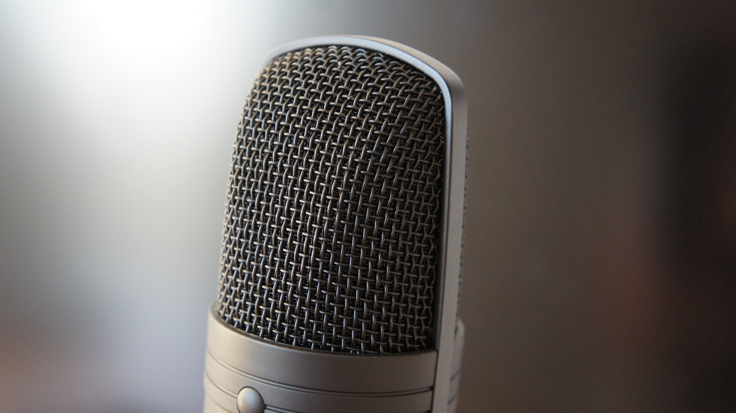 Close-up of a professional microphone symbolizing the audio capture necessary for AI-powered voice cloning. Close-up of a professional microphone symbolizing the audio capture necessary for AI-powered voice cloning.