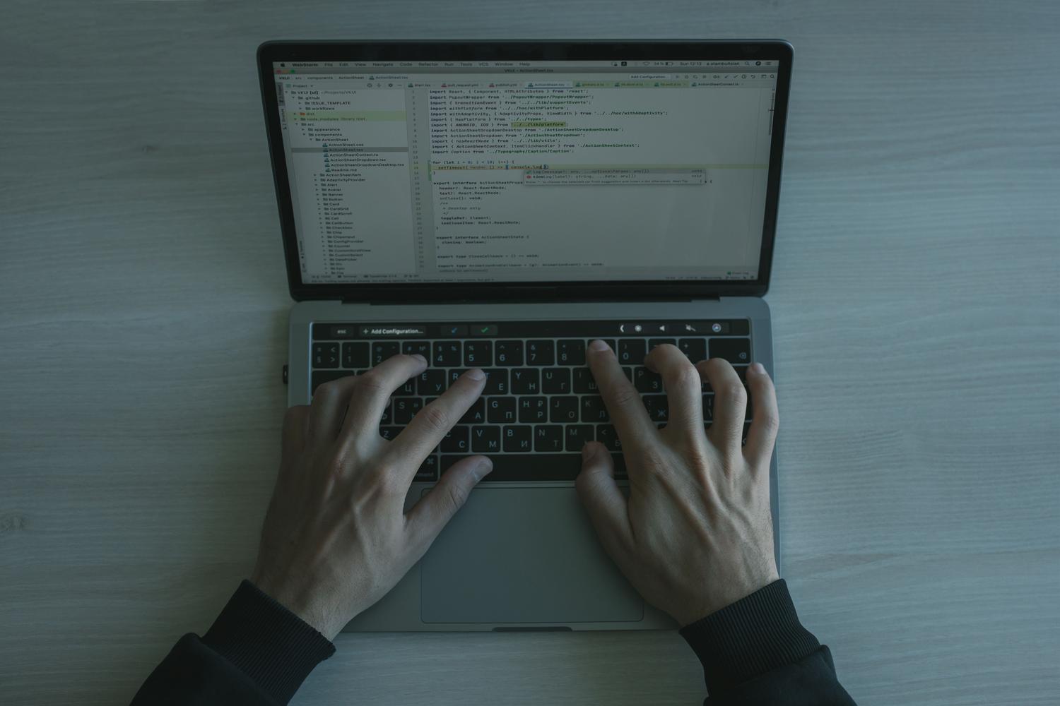 Hands typing on a laptop keyboard, symbolizing the process of following a technical tutorial to fix system settings.